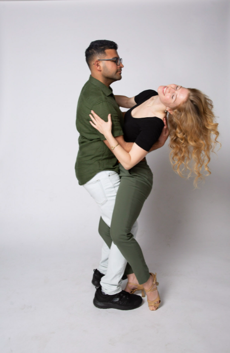 A dance couple posing in a beautiful and romantic bachata dip, a typical dance move in Bachata.